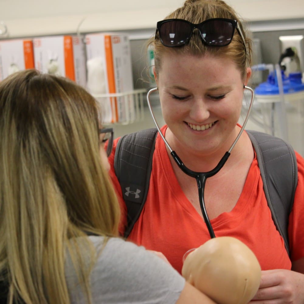 Student with stethoscope participated in nursing simulation