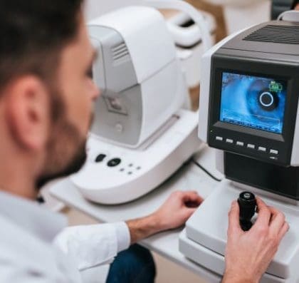 Optomotrist examining an eye